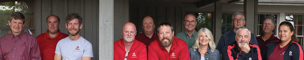 The vegetable consultants posing for a picture outside on a porch.
